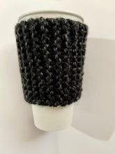 Load image into Gallery viewer, Hand knitted black coffee koozie with wood toggle button for decoration.
