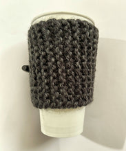 Load image into Gallery viewer, Hand knitted black coffee koozie with wood toggle button for decoration.
