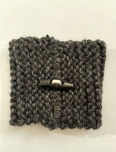 Load image into Gallery viewer, Hand knitted black coffee koozie with wood toggle button for decoration.
