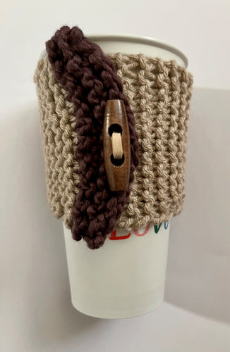 Hand knitted brown and burgundy coffee koozie with wood toggle button for decoration.