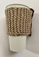 Load image into Gallery viewer, Hand knitted brown and burgundy coffee koozie with wood toggle button for decoration.
