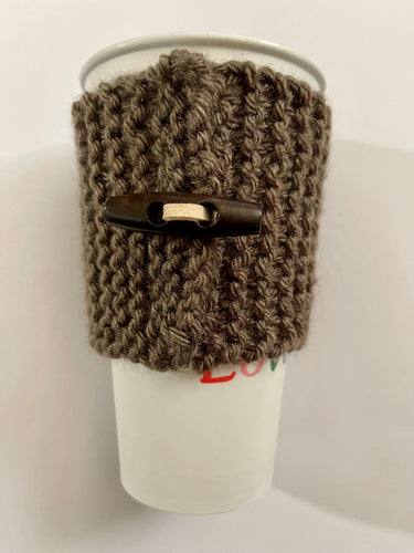 Hand knitted dark brown coffee koozie with dark brown wood toggle button for decoration.