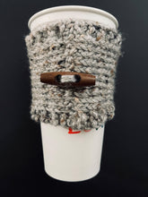 Load image into Gallery viewer, Hand knitted gray coffee koozie with wood toggle button for decoration.
