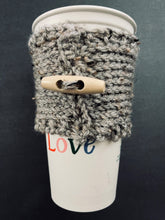 Load image into Gallery viewer, Hand knitted gray coffee koozie with wood toggle button for decoration.
