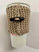 Load image into Gallery viewer, Hand knitted light brown coffee koozie with wood toggle button for decoration.
