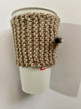 Load image into Gallery viewer, Hand knitted light brown coffee koozie with wood toggle button for decoration.
