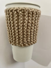 Load image into Gallery viewer, Hand knitted light brown coffee koozie with wood toggle button for decoration.
