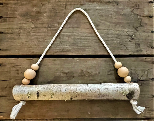 Natural birch log jewelry holder with peach beads