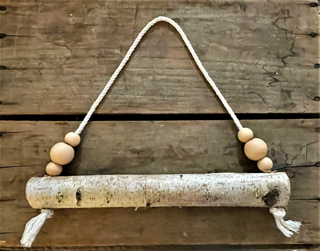 Natural birch log jewelry holder with peach beads