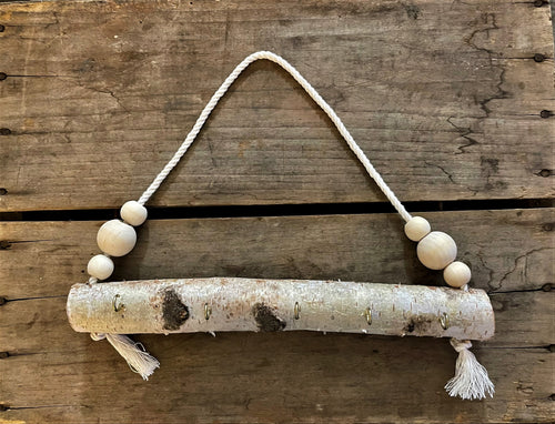 Natural birch log jewelry holder with white beads