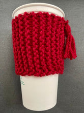 Load image into Gallery viewer, Hand knitted red scarf coffee koozie with red tassel.
