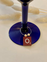 Load image into Gallery viewer, Red scrabble tile wine charm on a silver hoop wit 2 wooden beads.

