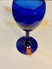Load image into Gallery viewer, Red scrabble tile wine charm on a silver hoop wit 2 wooden beads.
