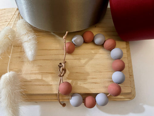 Stackable natural wood bead bracelet on leather cord