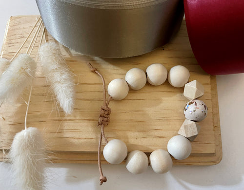 Stackable natural wood bead bracelet on leather cord