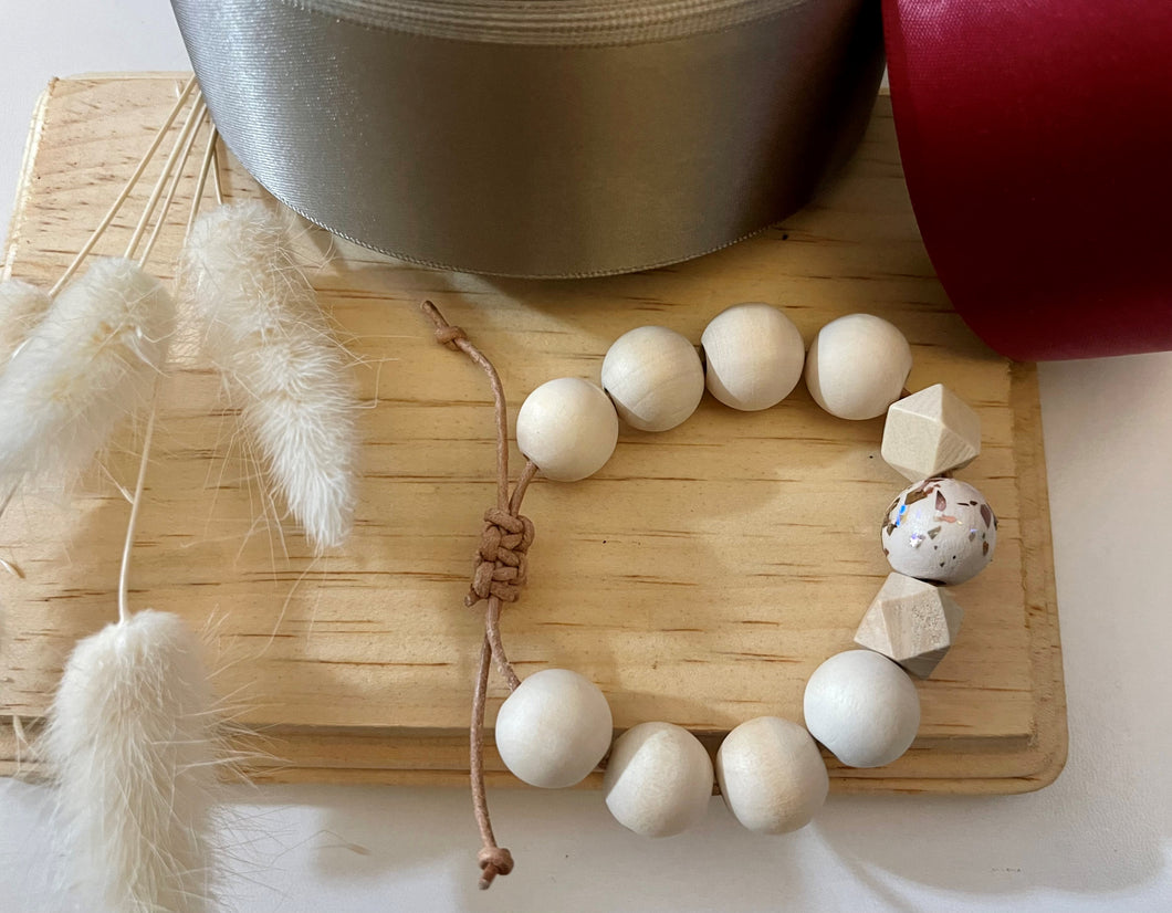 Stackable natural wood bead bracelet on leather cord