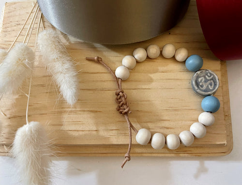 Stackable natural wood bead bracelet on leather cord