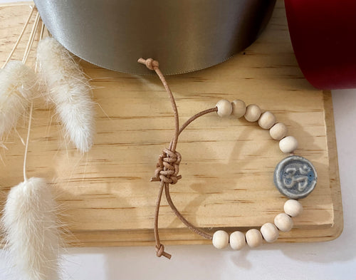 Stackable natural wood bead bracelet with stone ohm sign bead on leather cord