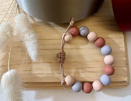Stackable natural wood bead bracelet on leather cord