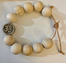 Load image into Gallery viewer, Stackable natural wood bead bracelet with stone ohm sign bead on leather cord
