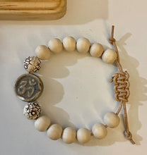 Load image into Gallery viewer, Stackable natural wood bead bracelet with stone ohm sign bead on leather cord
