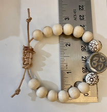 Load image into Gallery viewer, Stackable natural wood bead bracelet with stone ohm sign bead on leather cord
