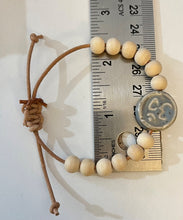 Load image into Gallery viewer, Stackable natural wood bead bracelet with stone ohm sign bead on leather cord
