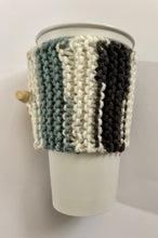 Load image into Gallery viewer, Knitted coffee koozie with mustard, beige, green, brick and black stripes. Beige wood toggle button for decoration.
