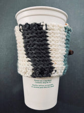 Load image into Gallery viewer, Hand knitted coffee koozie with beige, mustard, green and black with wood toggle button for decoration.
