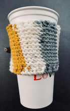 Load image into Gallery viewer, Hand knitted coffee koozie with beige, mustard, green and black with wood toggle button for decoration.
