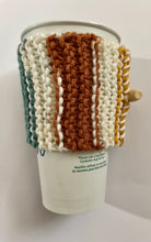 Load image into Gallery viewer, Knitted coffee koozie with mustard, beige, green, brick and black stripes. Beige wood toggle button for decoration.
